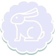 A white rabbit sitting on top of a green background.